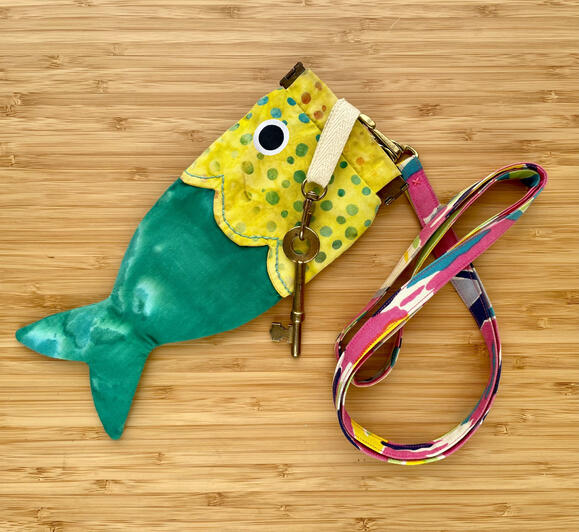 Handmade fish bag with interior key clasp, attached to a handmade lanyard strap